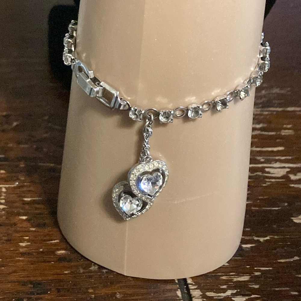 Trifari vintage bracelet with dangling hearts and shiny rhinestones make band
